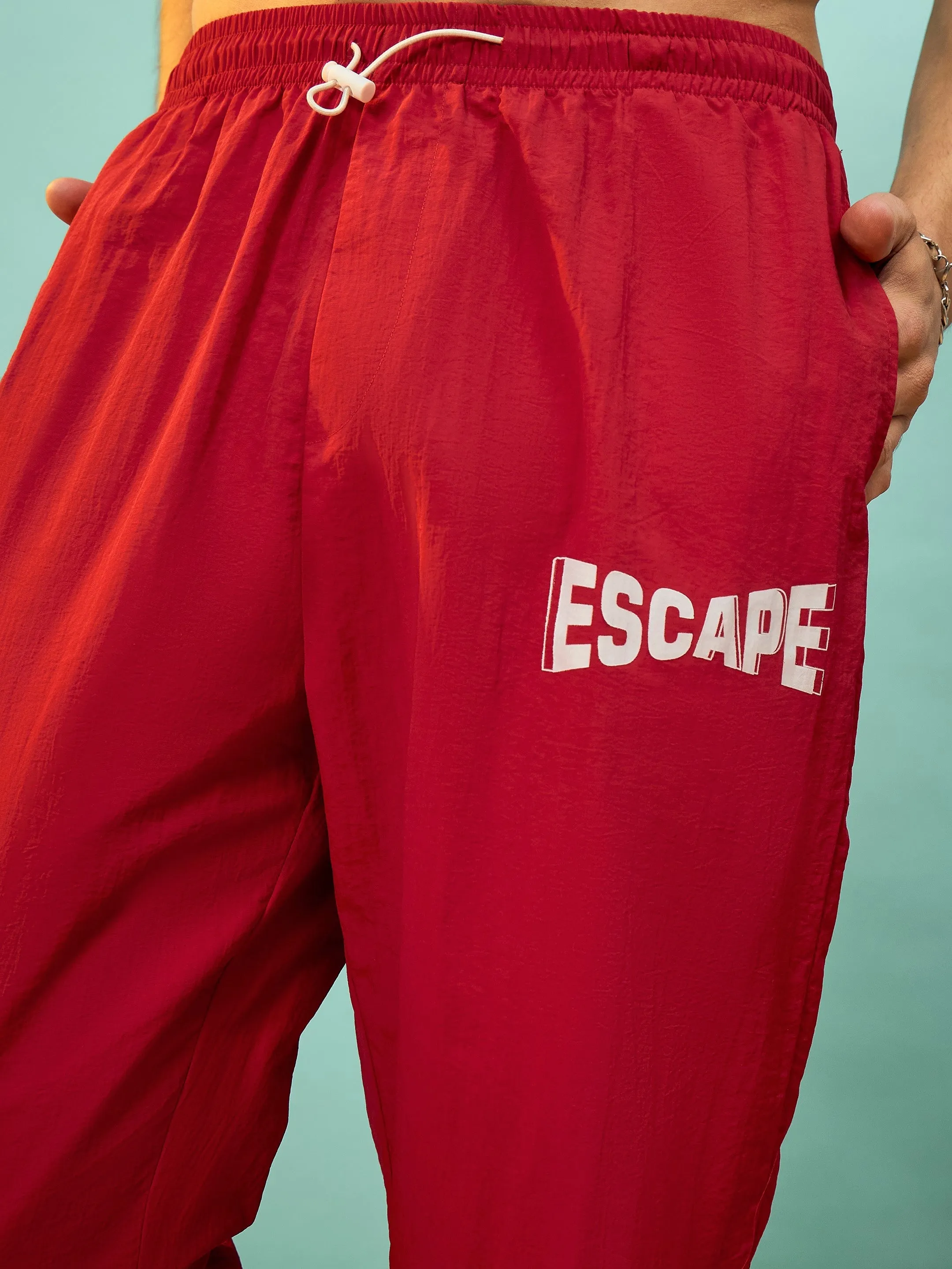 Men Red ESCAPE Print Parachute Pants