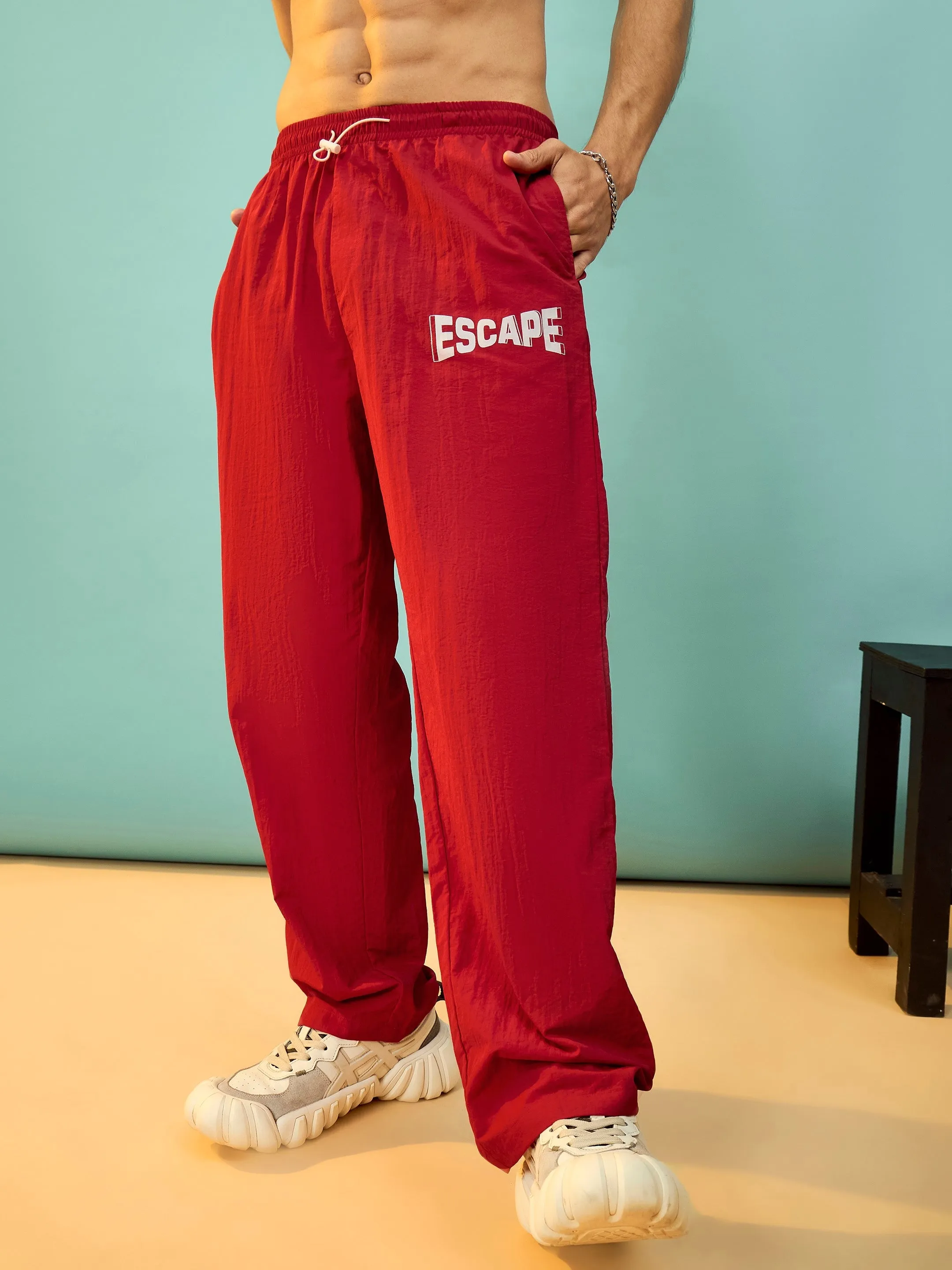 Men Red ESCAPE Print Parachute Pants