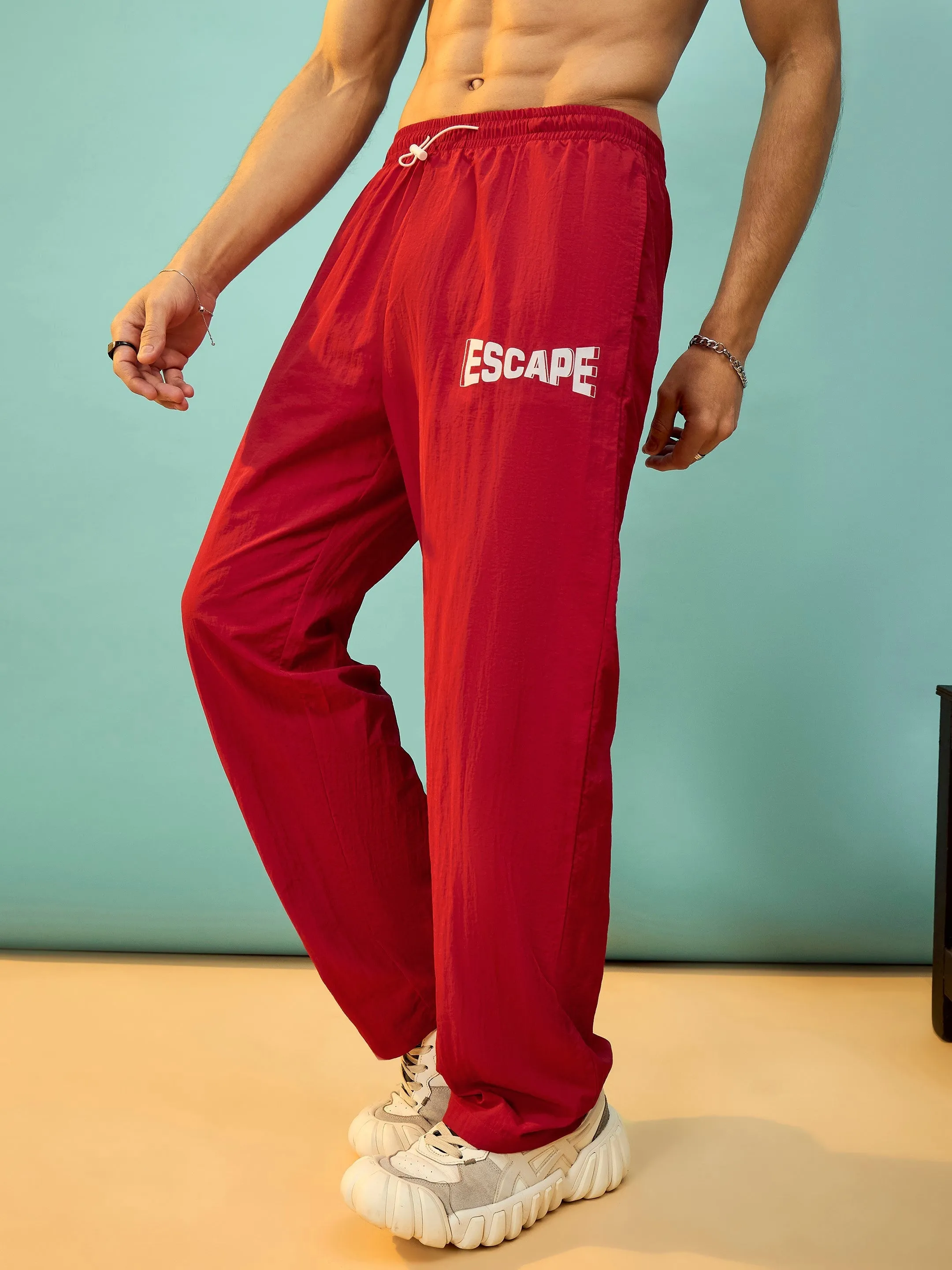 Men Red ESCAPE Print Parachute Pants